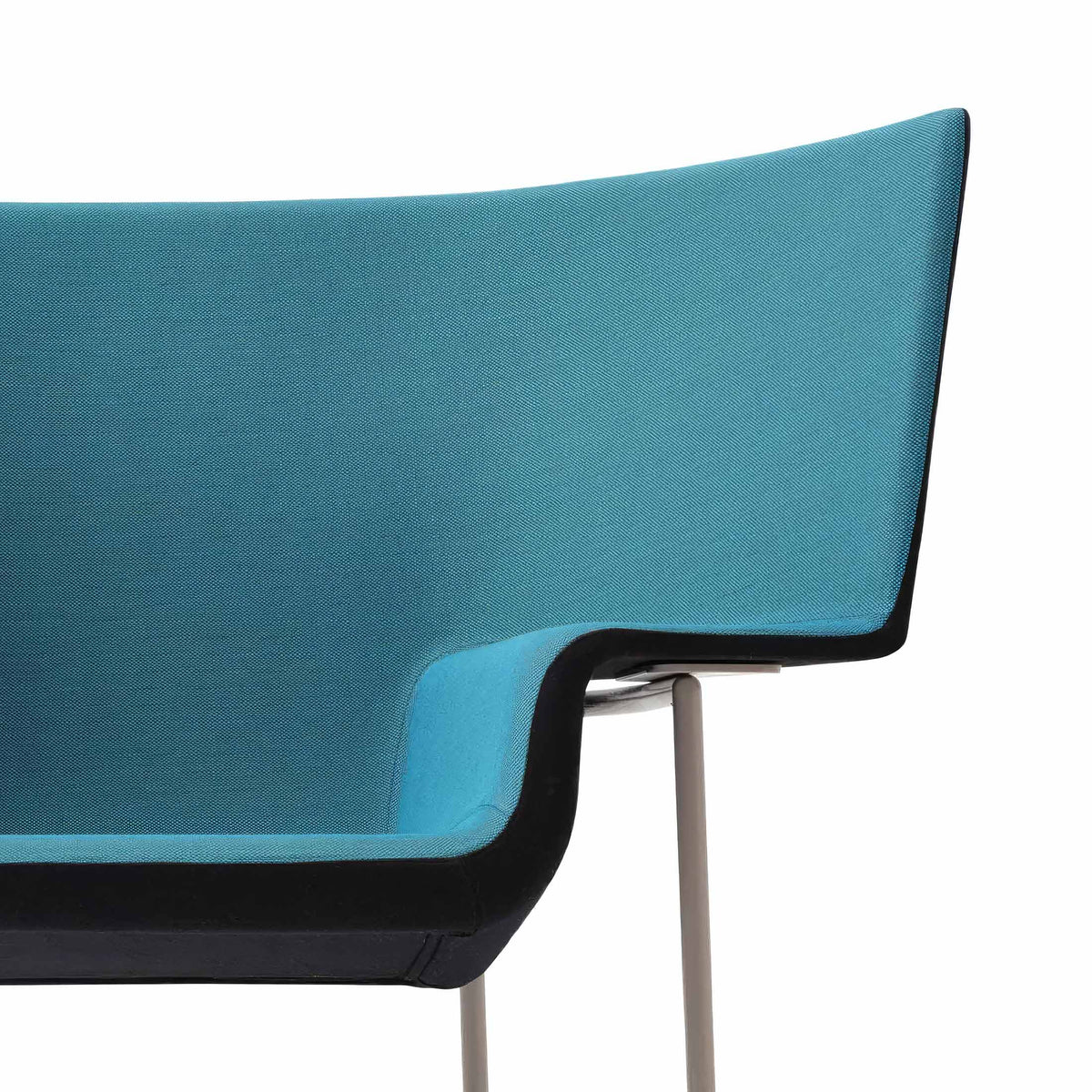 Cappellini Capo by Doshi Levien. A turquoise fabric chair with black trim and metallic legs against a white background.