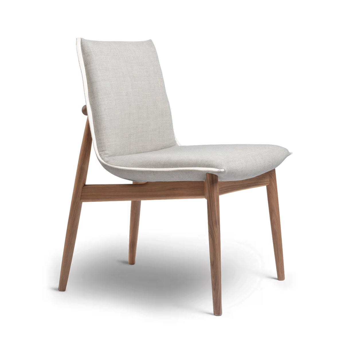 Carl Hansen & Søn E004 Embrace Chair by EOOS. A light beige upholstered chair with a warm walnut wood frame.