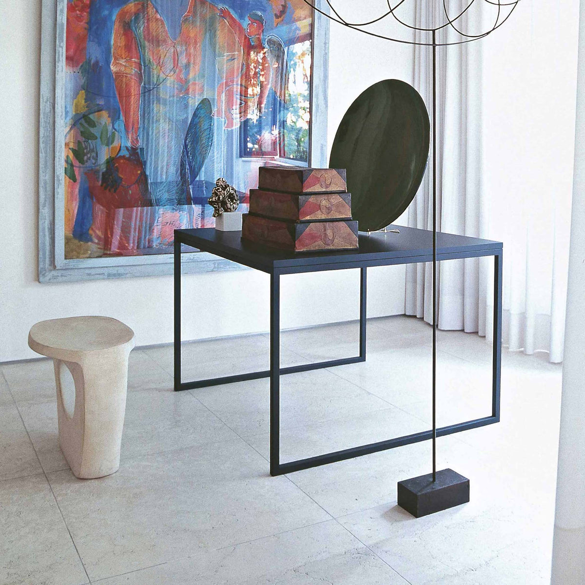 Cappellini Fronzoni '64 Table by AG Fronzoni 1964. A minimalist gallery displays sculptural objects on a black metal table.