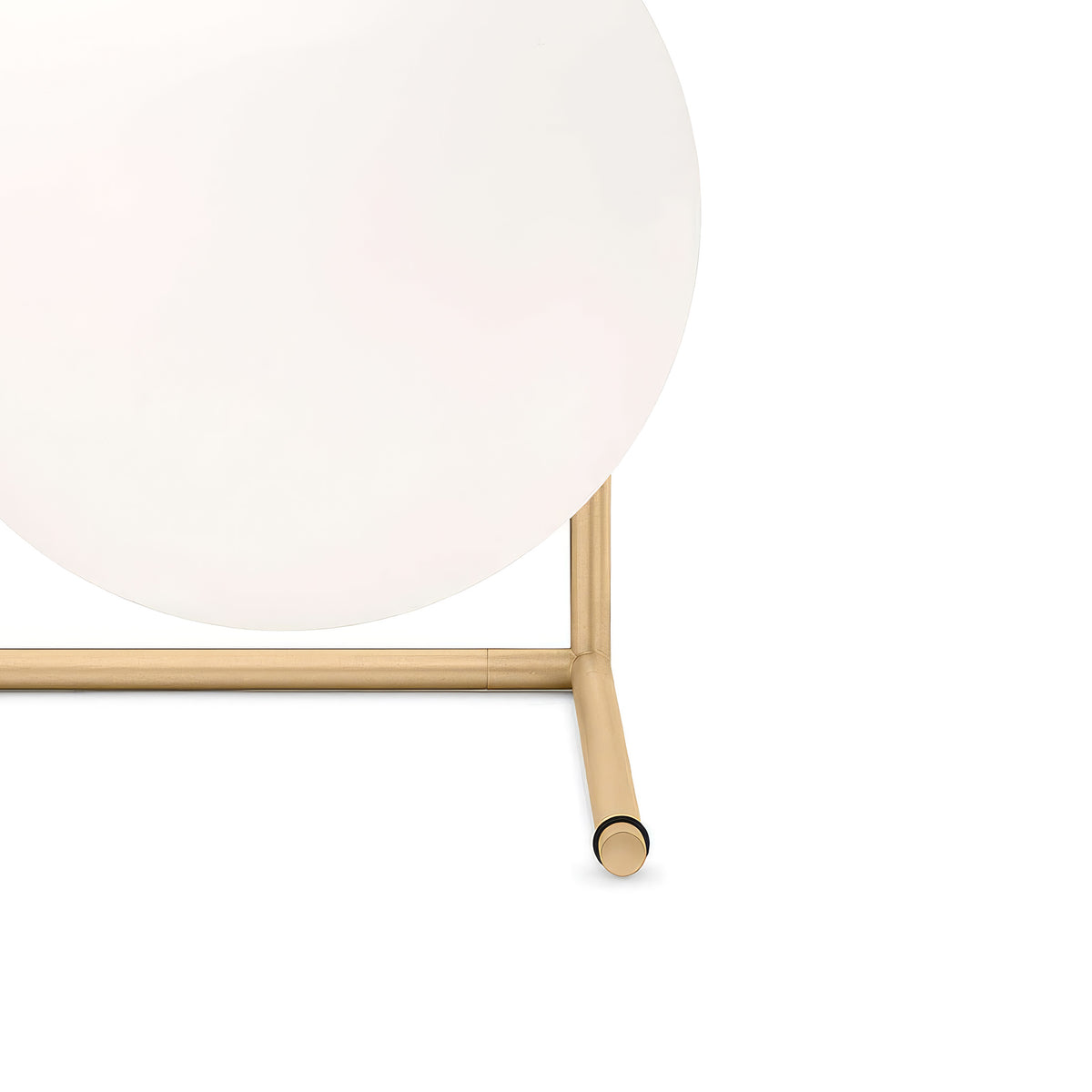 Flos IC Lights T2 by Michael Anastassiades. A frosted white globe rests on a brass arm with a modern, minimalist design.