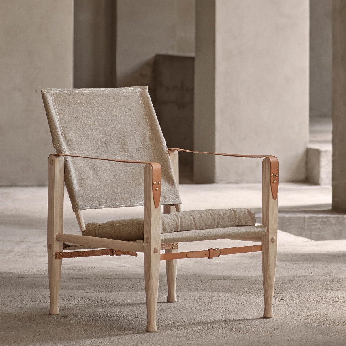 Carl Hansen & Søn KK47000 Safari Chair by Kaare Klint. Light wood frame with beige canvas and leather straps.