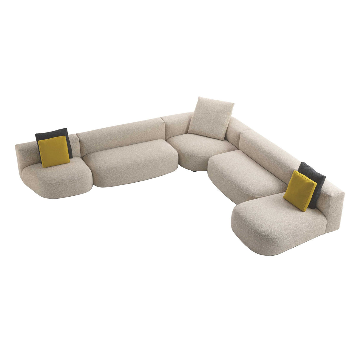 Cappellini Litos by Sebastian Herkner. Curved cream fabric sectional with yellow and black accent pillows.