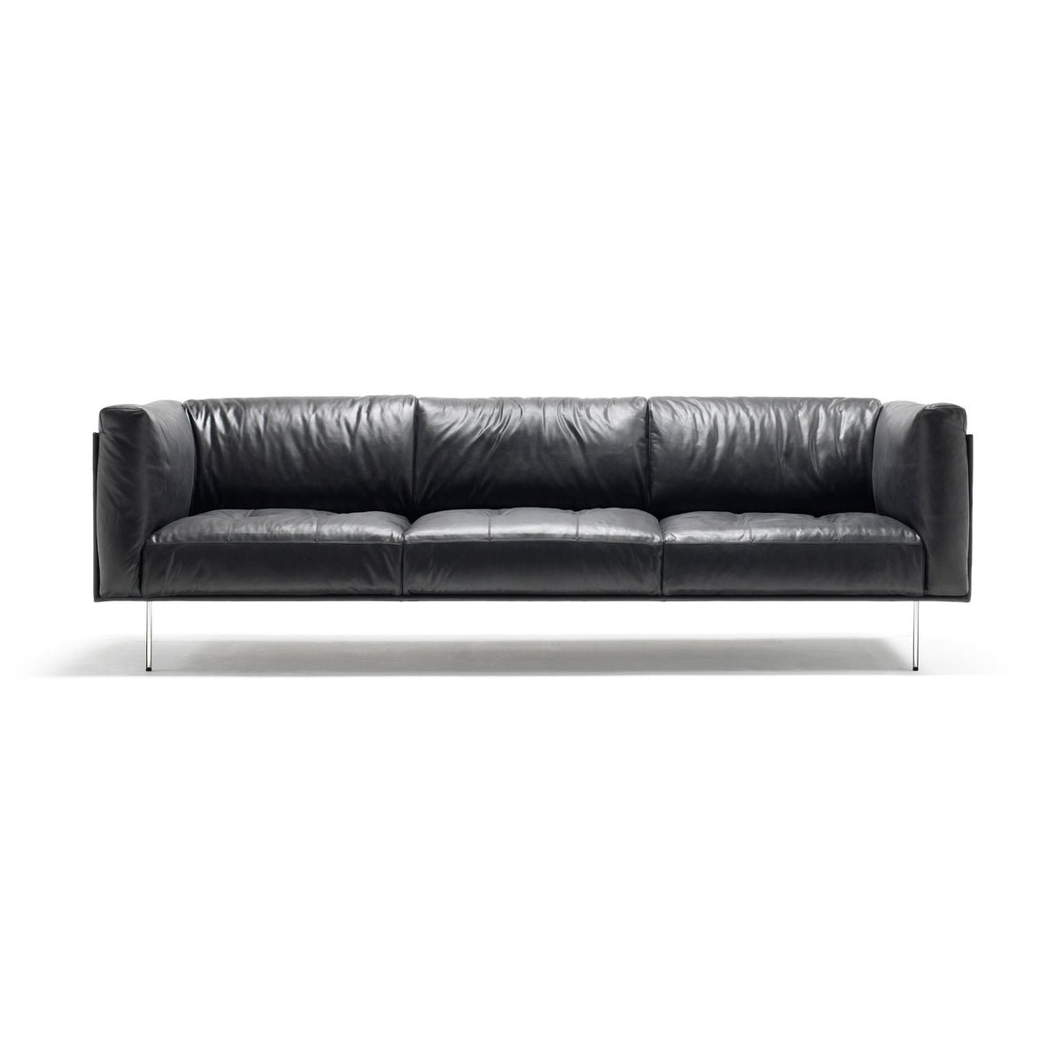 Living Divani Rod Sofa by Piero Lissoni. A sleek black leather sofa with metal legs sits against a white background.