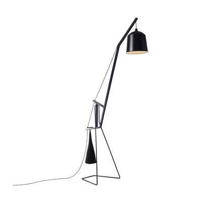 COVO A Floor Lamp by Aust & Amelung. A sleek black metal arc floor lamp with a cylindrical shade casts warm light.