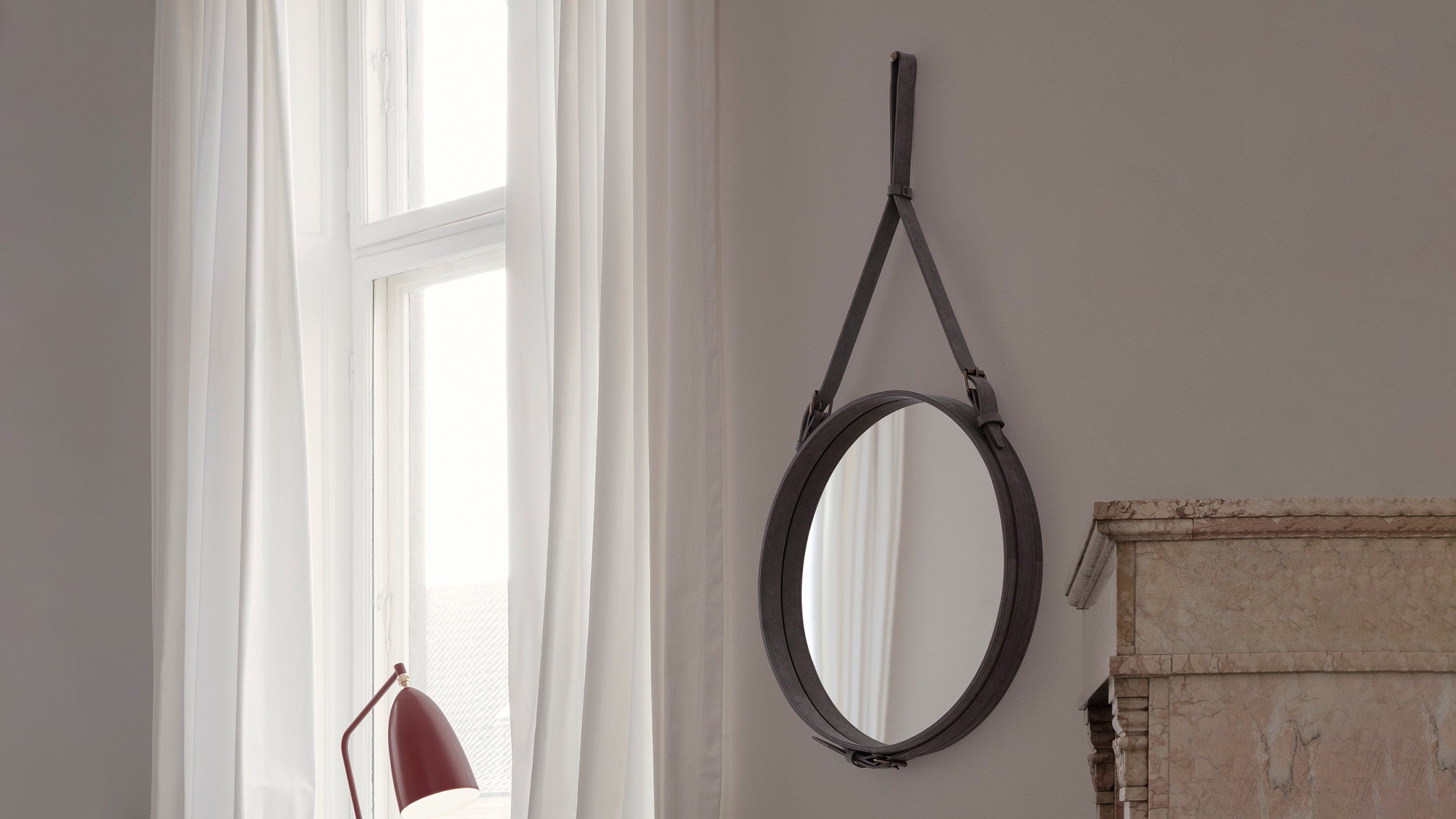Desktop / Adnet Wall Mirror, designed by Jacques Adnet and made by Gubi