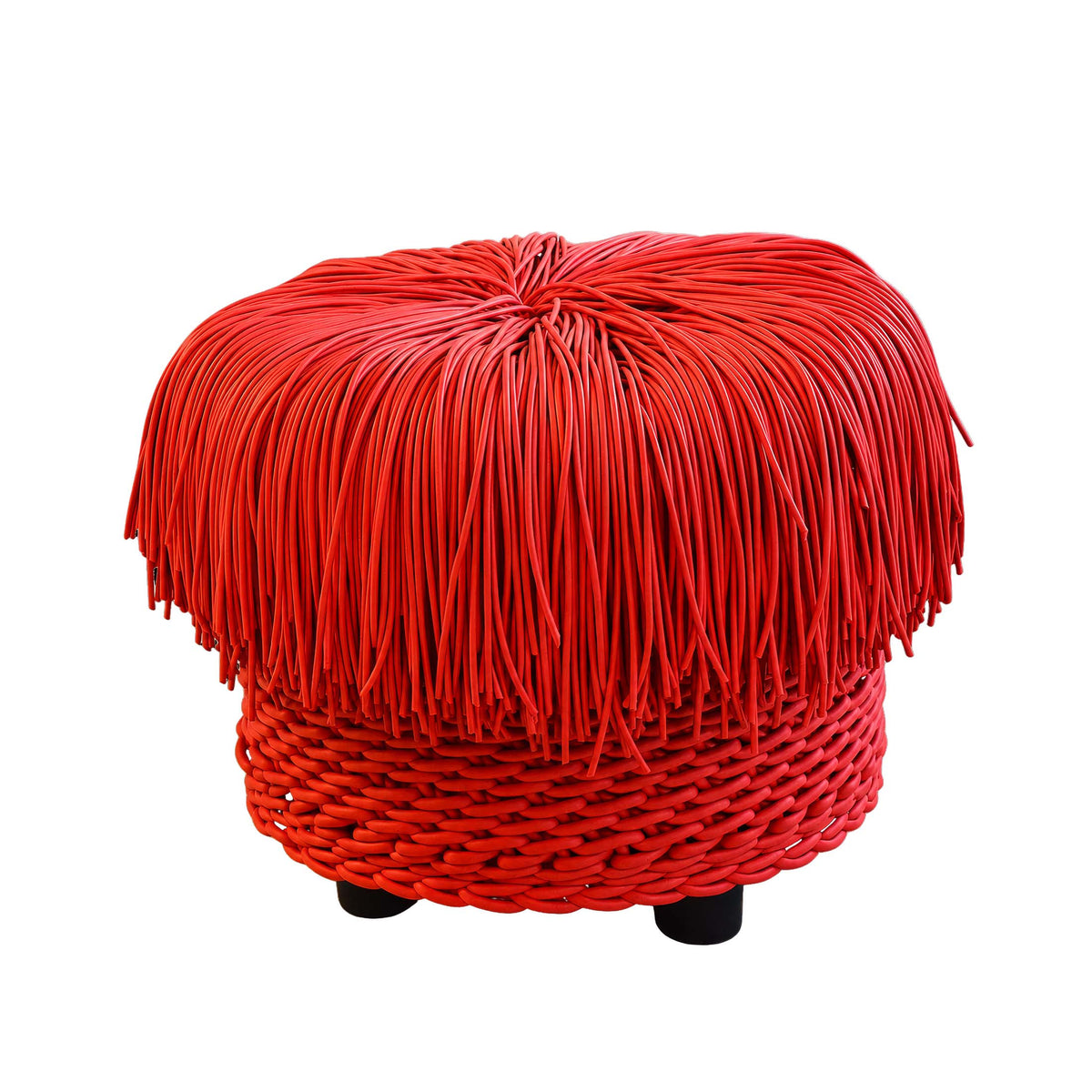 COVO Anemon Pouf by Rosanna Contadini. A bright red rope pouf with fringe top and woven base sits on black feet.