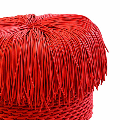 COVO Anemon Pouf by Rosanna Contadini. Red fringe and woven textile create a layered, textured decorative piece.