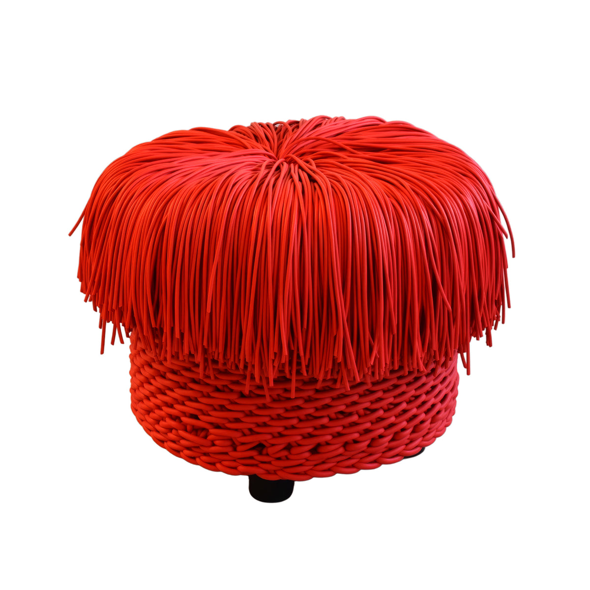 COVO Anemon Pouf by Rosanna Contadini. A bright red fringed pouf with a woven base and black leg.
