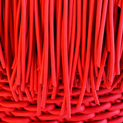 COVO Anemon Pouf by Rosanna Contadini. Layered red fabric strips create depth with rich crimson tones.