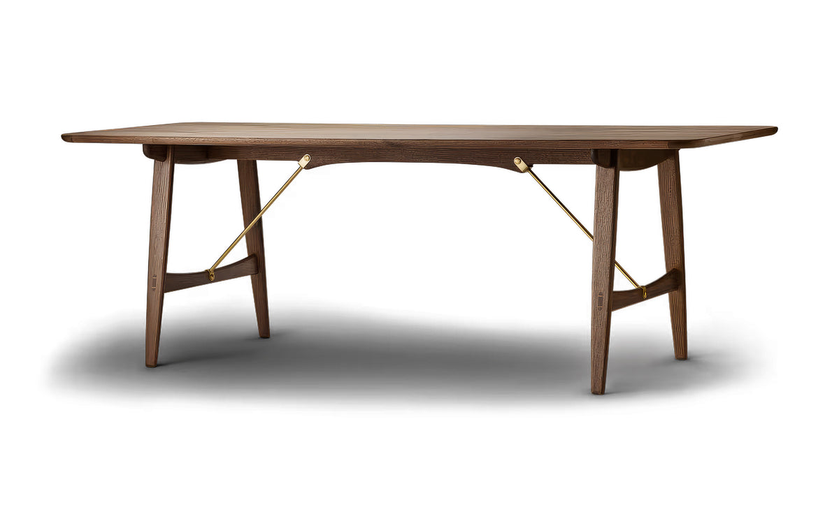 Carl Hansen & Søn BM1160 Hunting Table by Børge Mogensen. A wooden table with brass braces in a modern minimalist style.