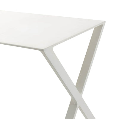 Cappellini Bambi by Nendo. A minimalist white table with a smooth matte finish and an X-shaped base design.