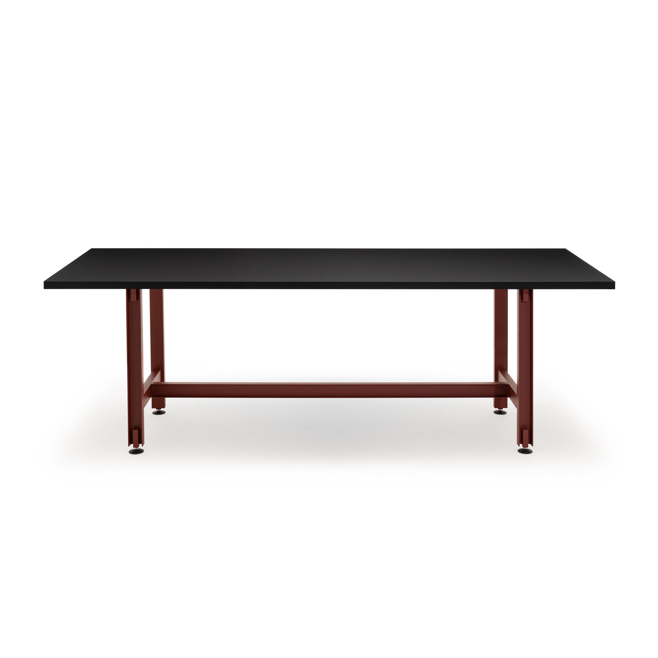 Established & Sons Beam Table by Konstantin Grcic. A black-topped table with dark red metal legs and crossbrace.