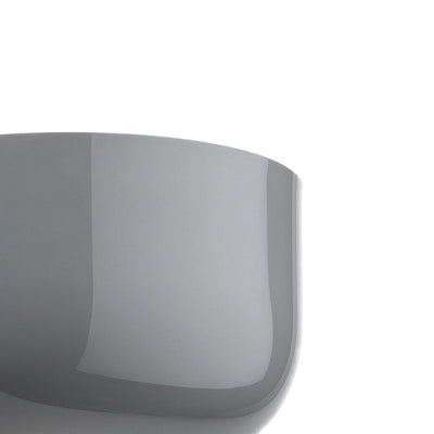 Flos Bellhop Wall Up by Edward Barber. A sleek, curved gray container with a glossy finish sits against a white background.