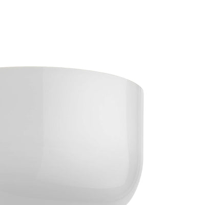 Flos Bellhop Wall Up by Edward Barber. A smooth, glossy white curved surface catches soft light against a pale background.