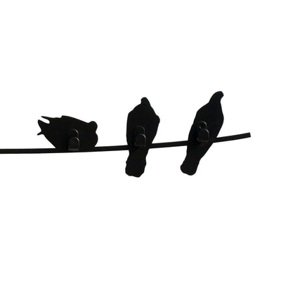 COVO Birds on Wire by Harry Allen. Three black silhouettes of birds perched together on a thin horizontal wire.
