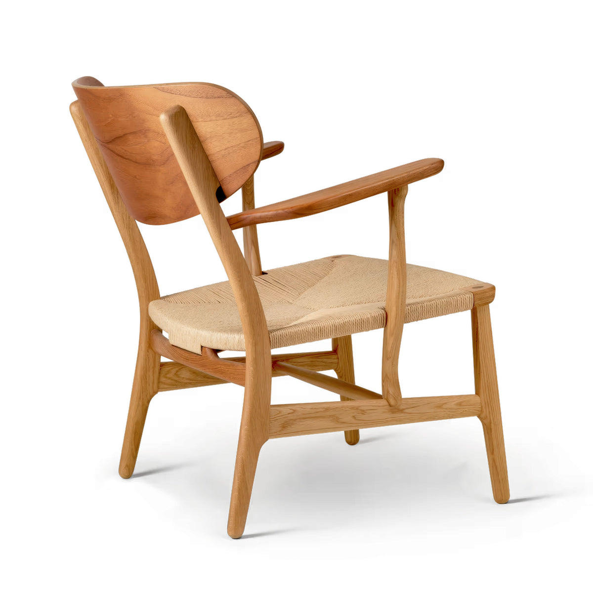 Carl Hansen & Søn CH22 Lounge Chair by Hans J. Wegner. Wooden chair with woven seat and curved backrest.