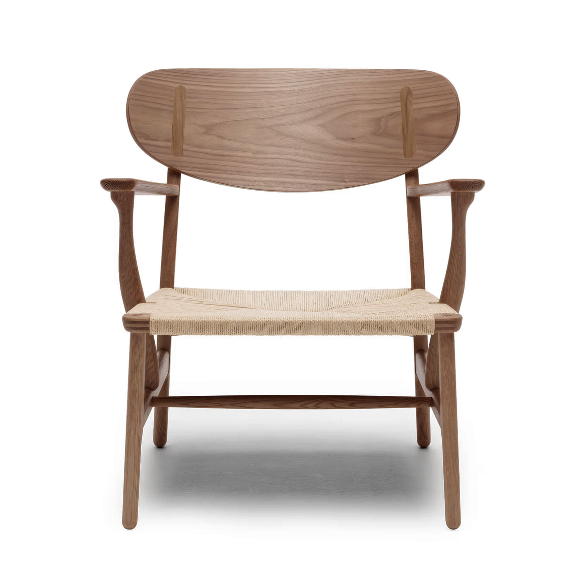 Carl Hansen & Søn CH22 Lounge Chair by Hans J. Wegner. Wooden chair with woven seat and curved backrest.