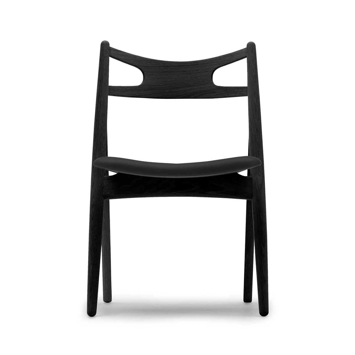 Carl Hansen & Søn CH29P Sawbuck Chair by Hans J. Wegner. A sleek black wooden chair with curved backrest and seat.