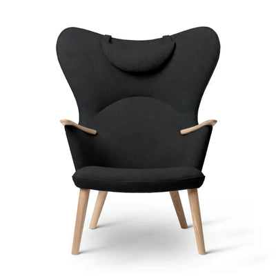 Carl Hansen & Søn CH78 Mama Bear Chair by Hans J. Wegner. Black fabric chair with wooden legs on white.