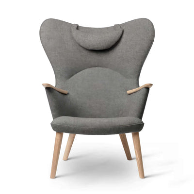 Carl Hansen & Søn CH78 Mama Bear Chair by Hans J. Wegner. A grey upholstered wingback chair with wooden legs.