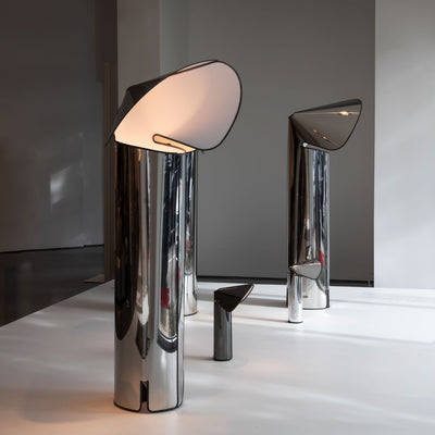 Flos Chiara Floor by Mario Bellini. Sleek chrome cylindrical lamps with tilted frosted glass shades emit warm light.