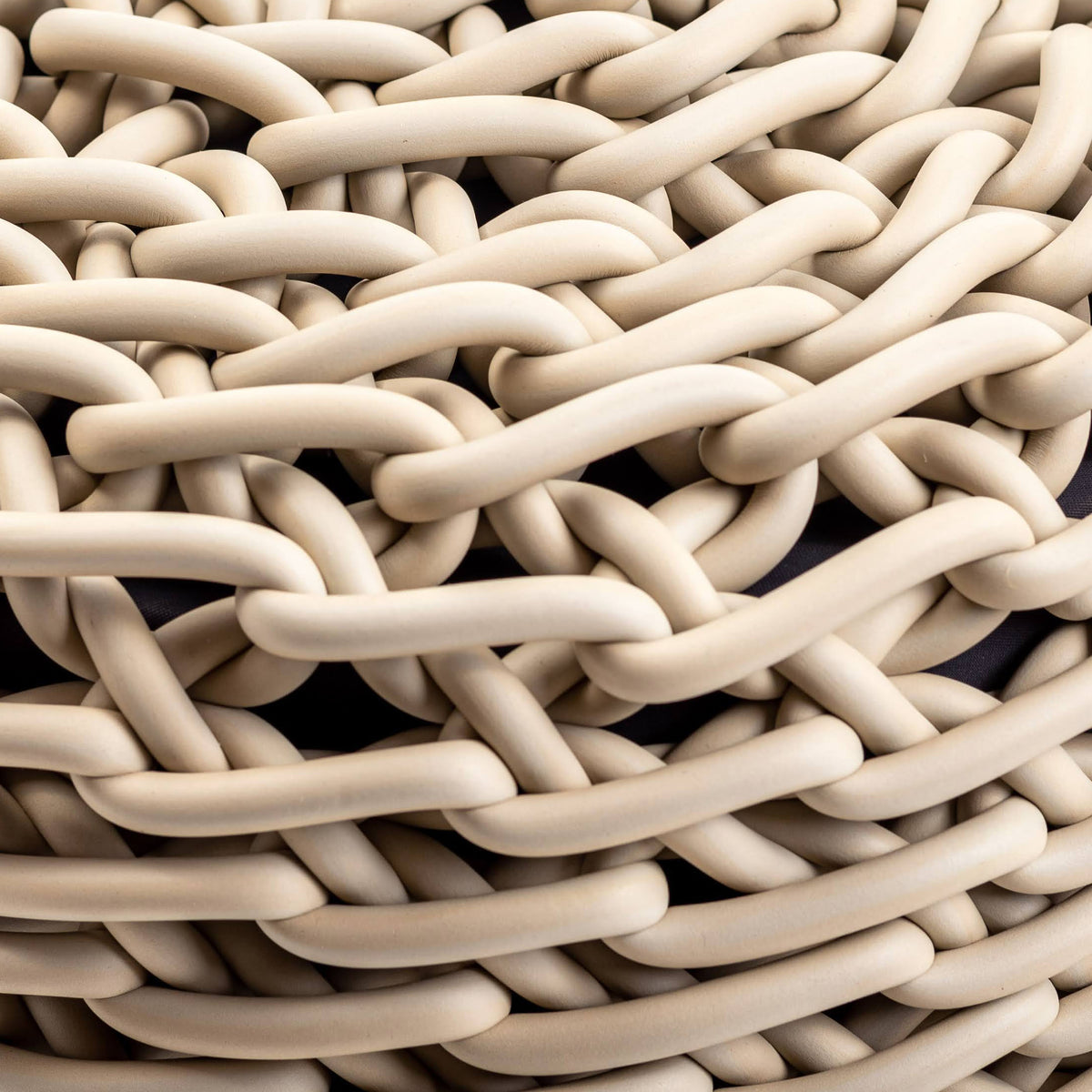 COVO Cilindro Pouf. Cream-colored twisted rope or cord strands are densely layered and interwoven in an abstract pattern.