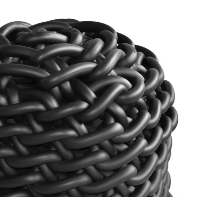 COVO Colosso pouf by Rosanna Contadini. Thick black rubber tubes coil tightly in an intricate woven pattern.