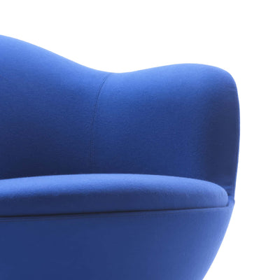 Cappellini Dalia by Marcel Wanders. A plush blue fabric chair with curved organic lines against a white background.