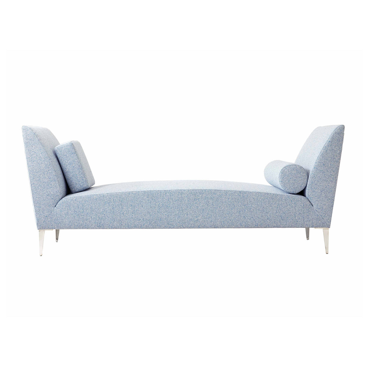 Cappellini Daybed by Jasper Morrison. A light blue upholstered daybed with angled armrests and cylindrical pillows.