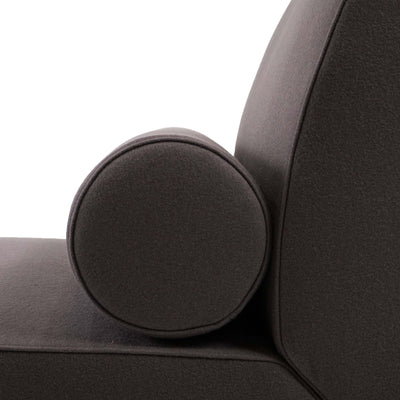 Cappellini Daybed by Jasper Morrison. A dark gray upholstered chair features a round decorative pillow.