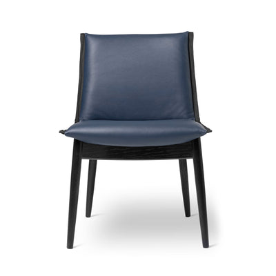 Carl Hansen & Søn E004 Embrace Chair by EOOS. A modern chair with a navy leather seat and black wooden frame.
