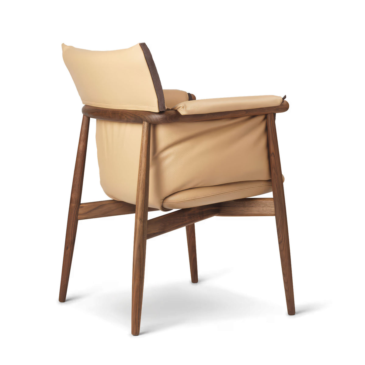 Carl Hansen & Søn E005 Embrace Armchair by EOOS. A cream leather chair with a dark wood frame and brown fabric accents.