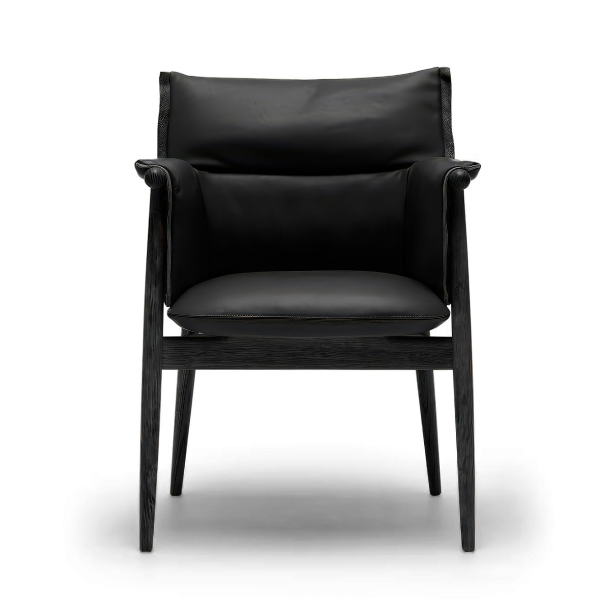 Carl Hansen & Søn E005 Embrace Armchair by EOOS. A sleek black leather chair with wooden frame and armrests.