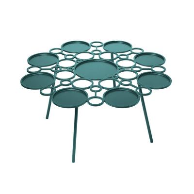 COVO Floret Table by Marta Laudani. A teal metal table features multiple circular platforms arranged in a geometric pattern.