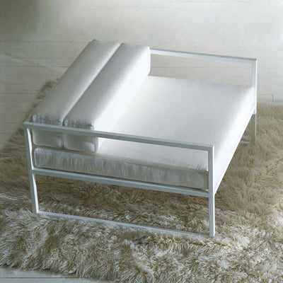 Cappellini Fronzoni '64 Armchair by AG Fronzoni 1964. White modern chair with rolled arms on a beige rug.