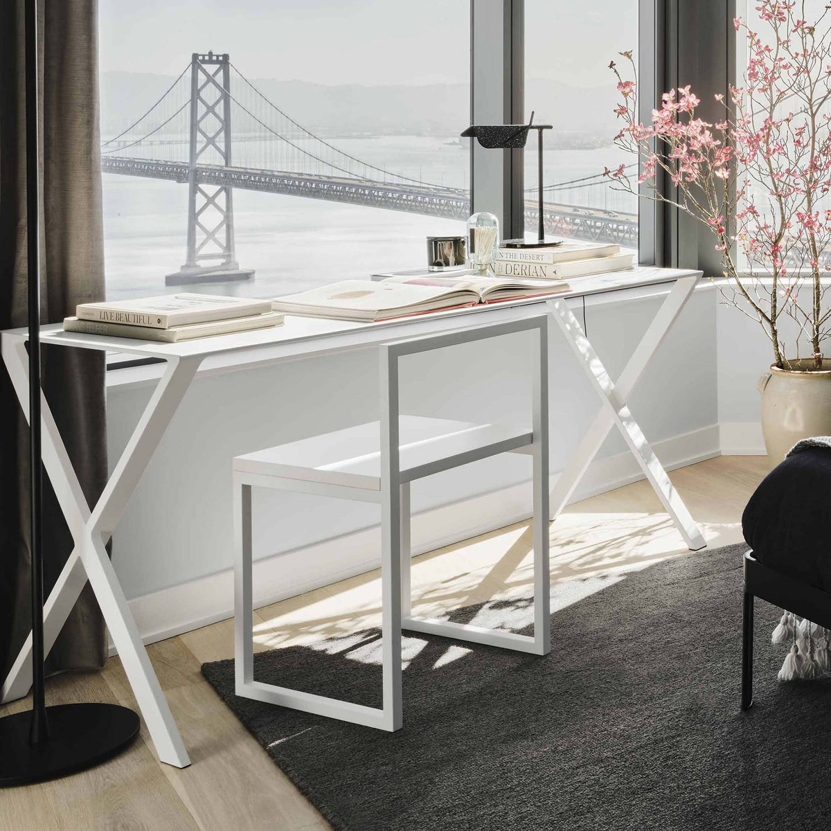 Cappellini Fronzoni '64 Chair by AG Fronzoni 1964. A white desk with X-frame legs overlooks a bridge view.
