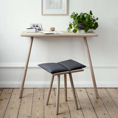 Fritz Hansen Georg Console Table by Chris Liljenberg Halstrøm. Light wood desk with potted plant and small stool.