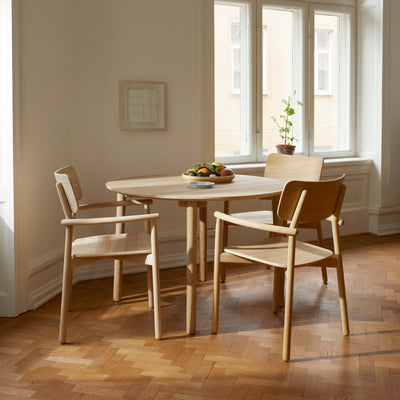 Fritz Hansen Hven Table by Anton Björsing. Light wood dining set with three chairs in a bright, minimalist room.