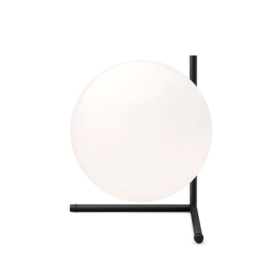 Flos IC Lights T2 by Michael Anastassiades. A frosted white sphere rests on a minimalist black metal stand.