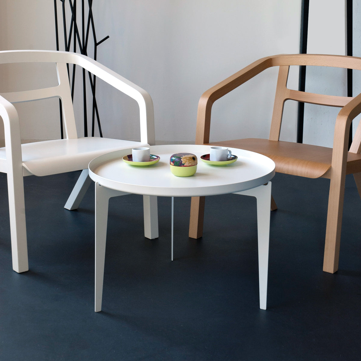 COVO Illusion - Two in One by Minna Niskakangas. Two modern chairs flank a white round table with lime green cups.