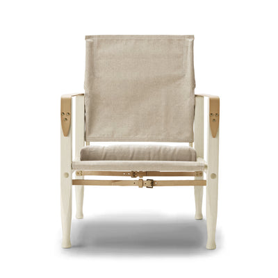Carl Hansen & Søn KK47000 Safari Chair by Kaare Klint. A cream canvas chair with wooden frame and leather straps.