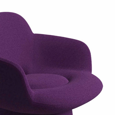 Cappellini Kwado by Sebastian Herkner. A plush purple fabric chair features soft, rounded curves and a modern design.