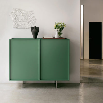Cappellini Lochness Cabinet by Piero Lissoni. A sage green cabinet with clean lines sits in a minimalist interior space.