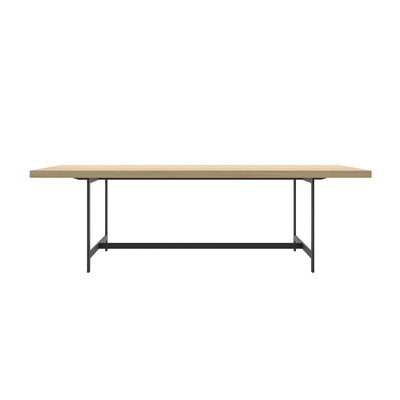 Cappellini Lochness Table by Piero Lissoni. A wooden table with a natural finish sits on a dark metal frame.