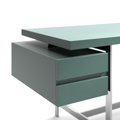 Cappellini Lochness Table by Piero Lissoni. A modern mint-green desk with two drawers and metal legs on white.