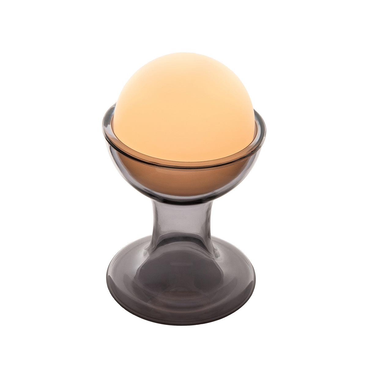 Established & Sons Gelato Lamp by Carlo Nason. A glowing amber sphere rests in a smoky gray glass pedestal base.