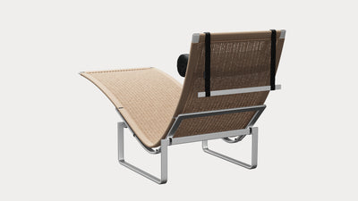 Desktop / PK24 Lounge Chair, designed by Poul Kjærholm and made by Fritz Hansen