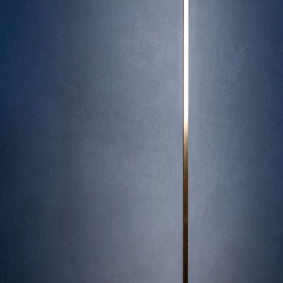 Davide Groppi Masai Floor Lamp by Maurizio Mancini. A sleek metallic line divides a cool blue textured surface.