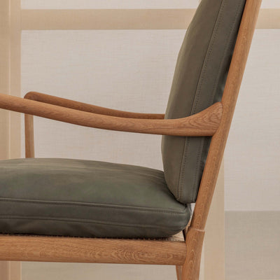 Carl Hansen & Søn OW149 Colonial Chair by Ole Wanscher. Wooden chair with olive green cushioned seat and back.