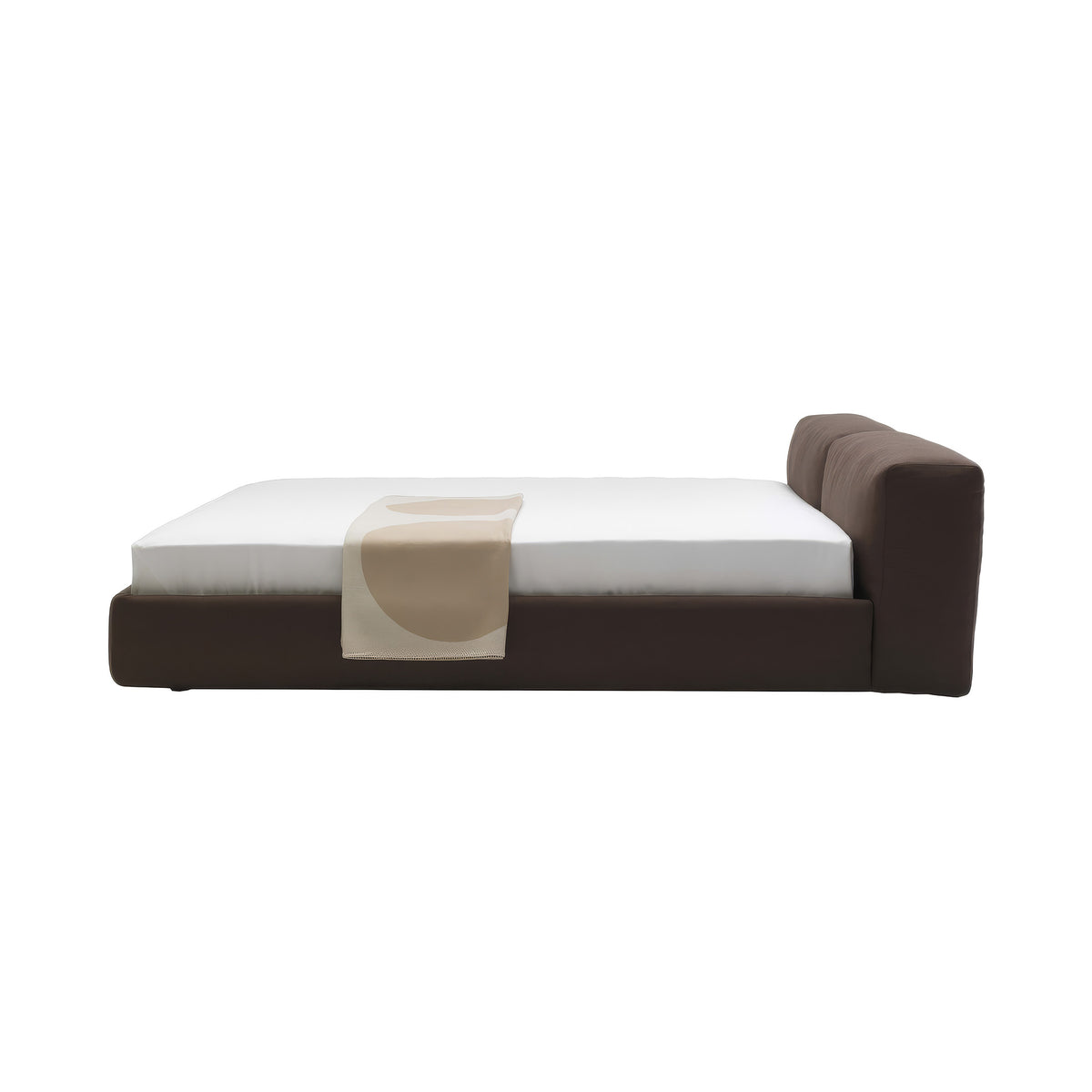 Cappellini Oblong Plus Bed by Jasper Morrison. A modern brown upholstered bed with white bedding and a beige throw.